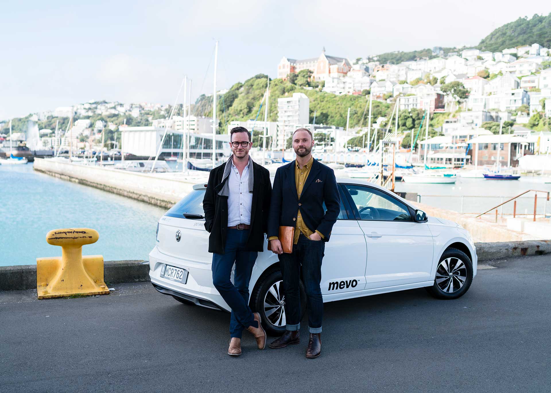 Erik and Finn standing next to a Mevo car on the Wellington waterfront.
